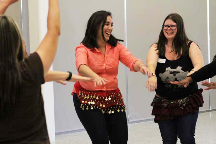 Staff practicing belly dancing