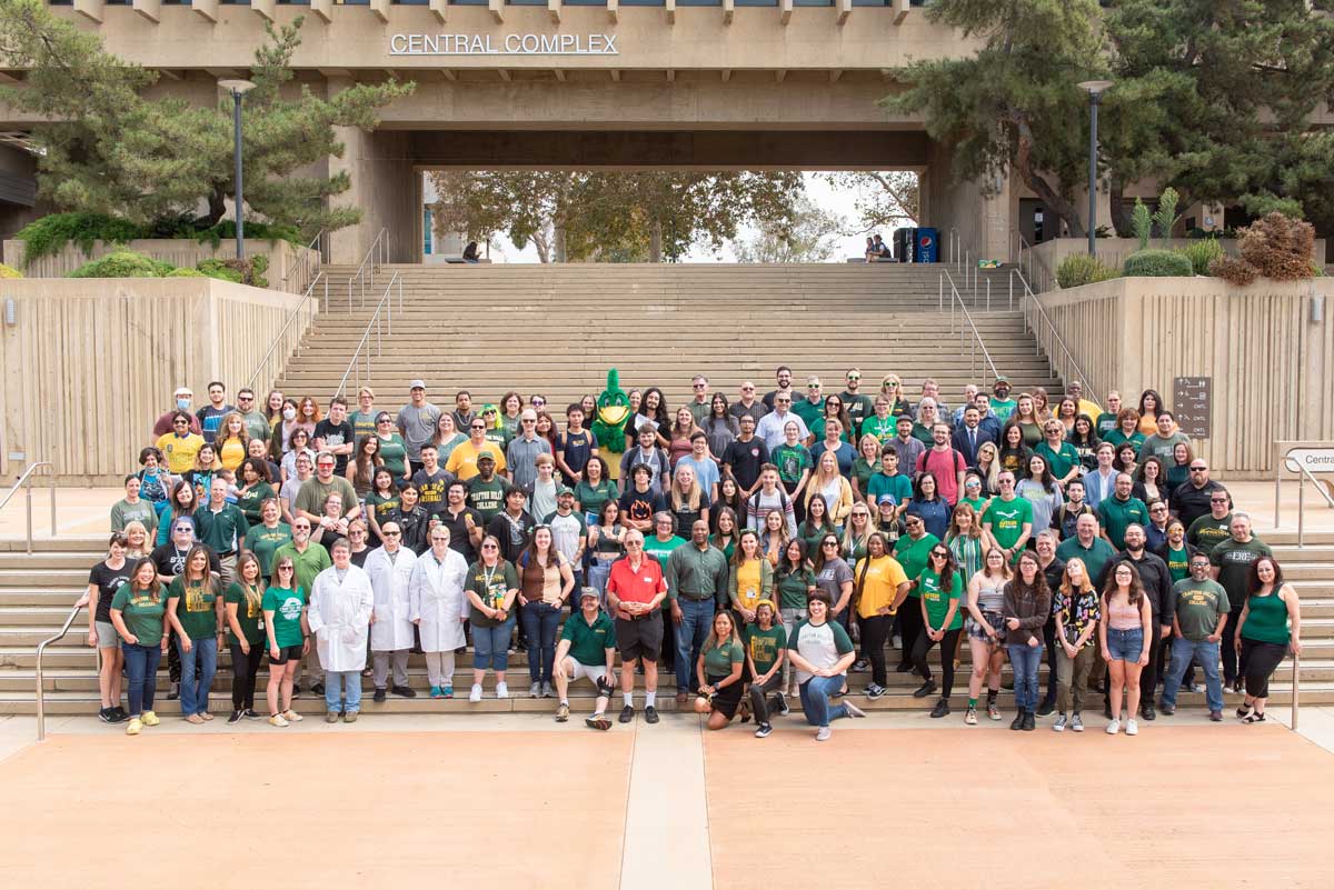 Students, staff, and mascot on large staircase