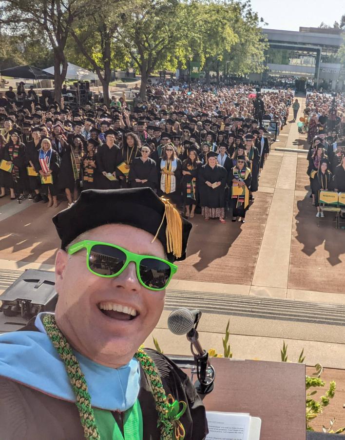 Photo of Kevin Horan with students at Commencement