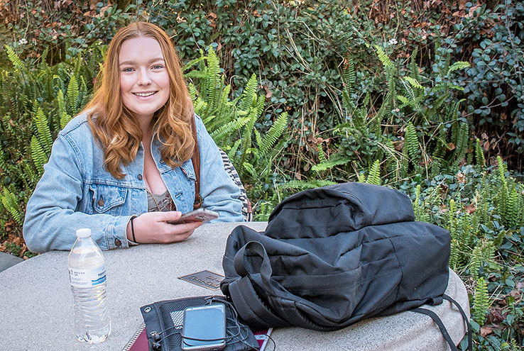 Woman sitting at a table outside