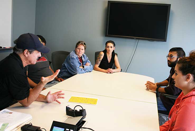 Students and staff in a support group discussion