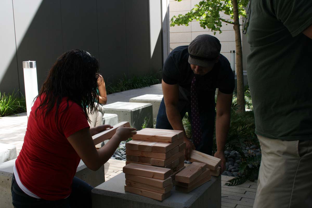 People playing giant Jenga