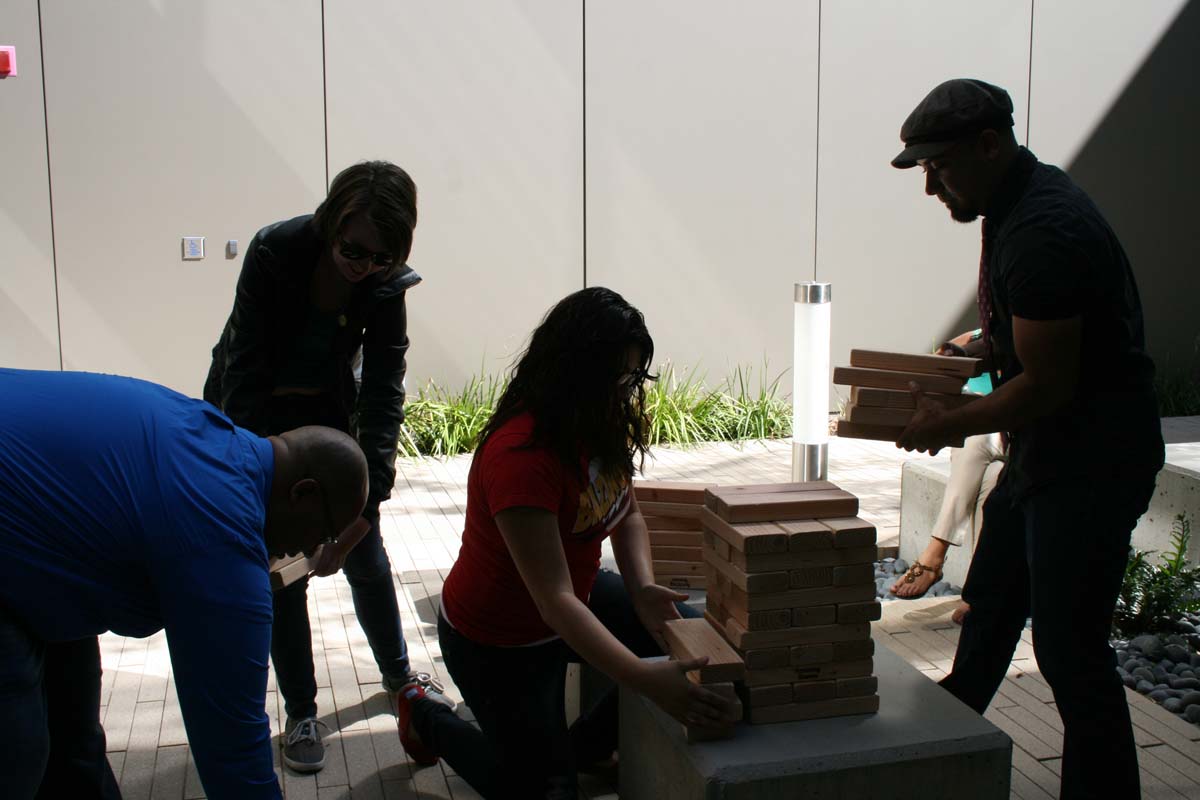 People playing giant Jenga
