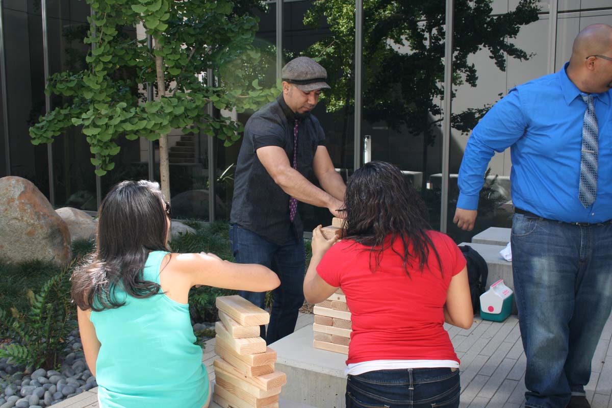 People playing giant Jenga