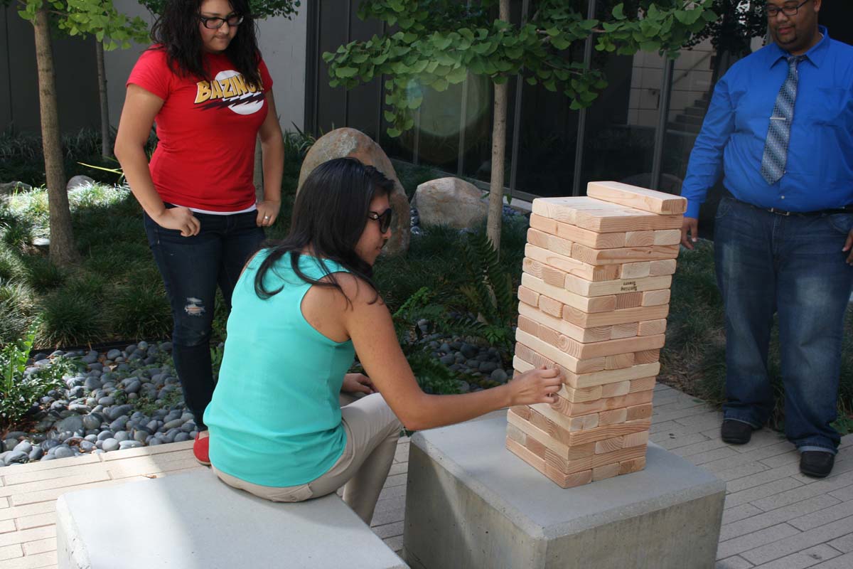 People playing giant Jenga