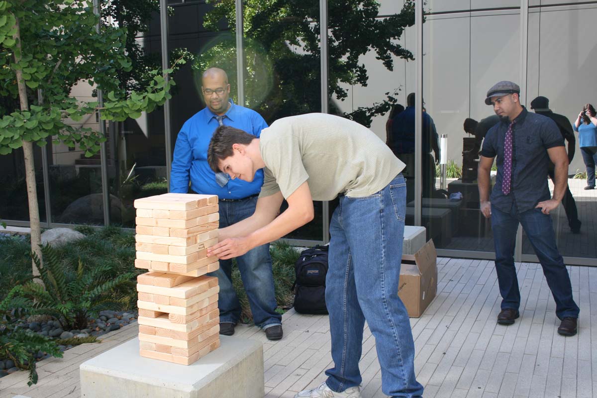 People playing giant Jenga