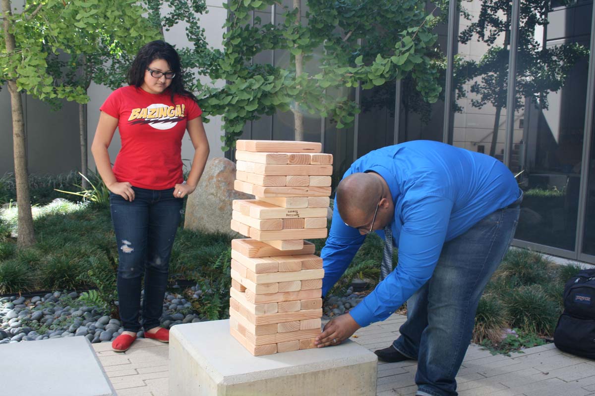 People playing giant Jenga