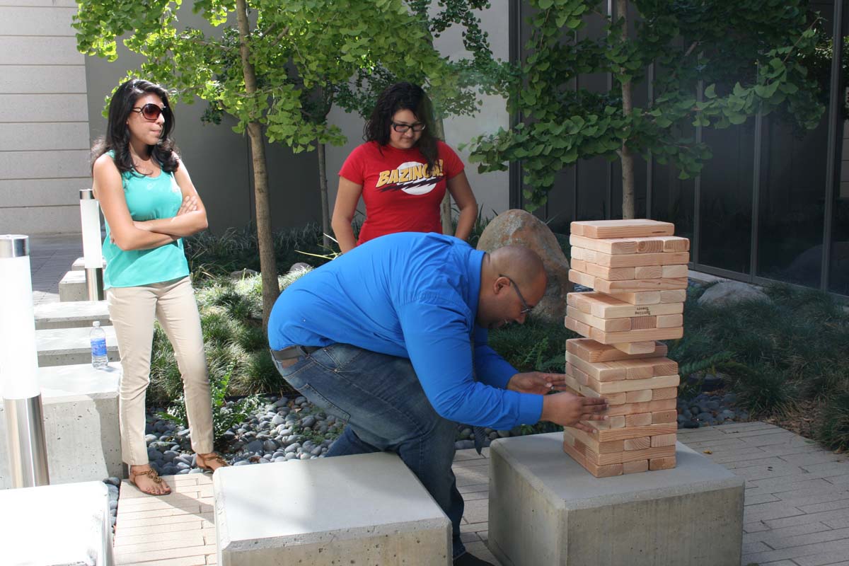 People playing giant Jenga