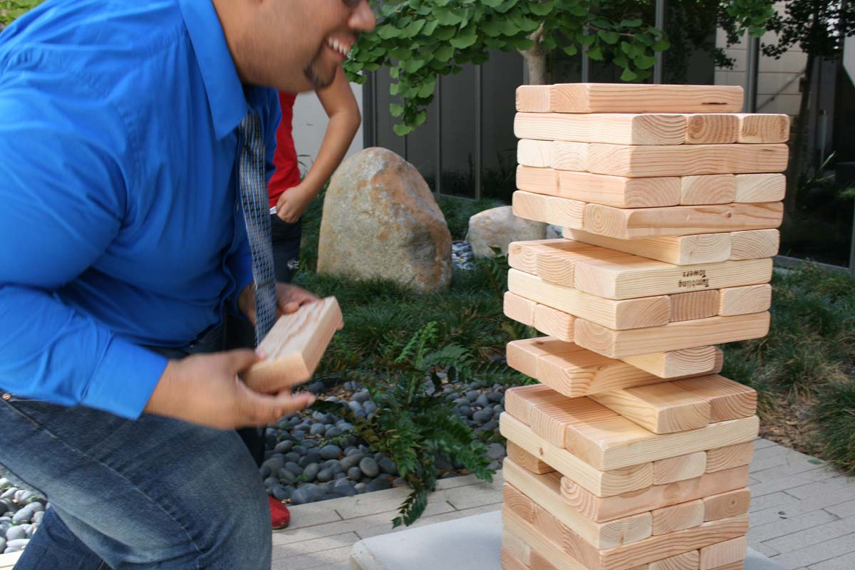 People playing giant Jenga