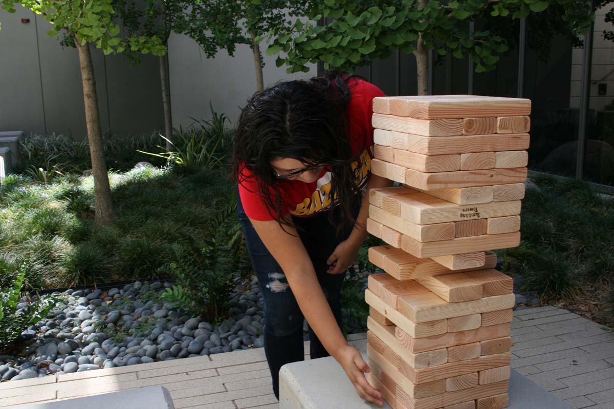 People playing giant Jenga