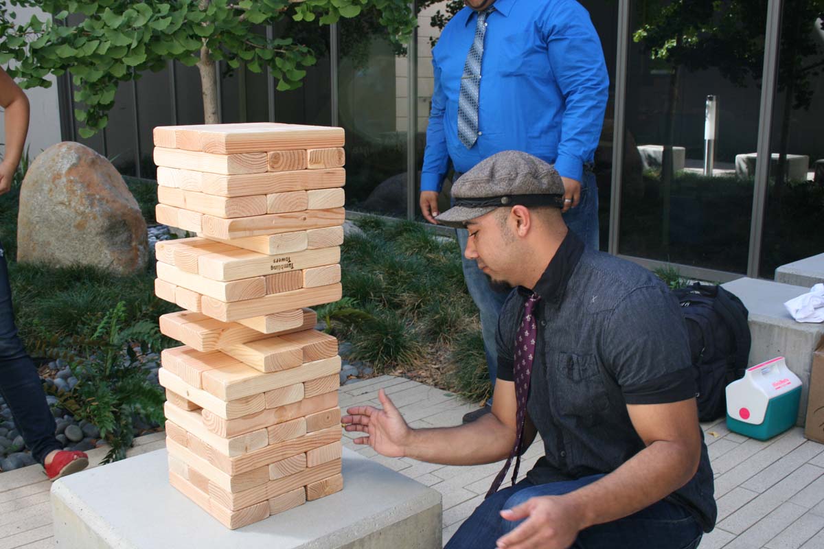 People playing giant Jenga