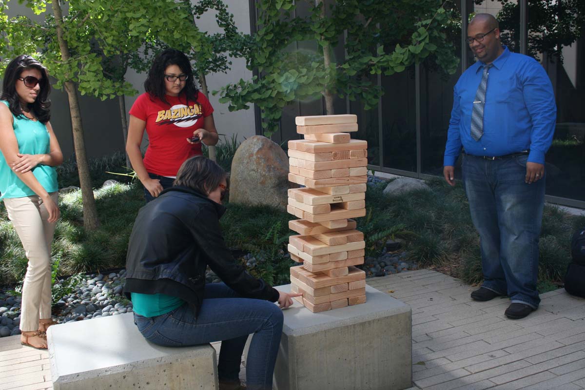 People playing giant Jenga