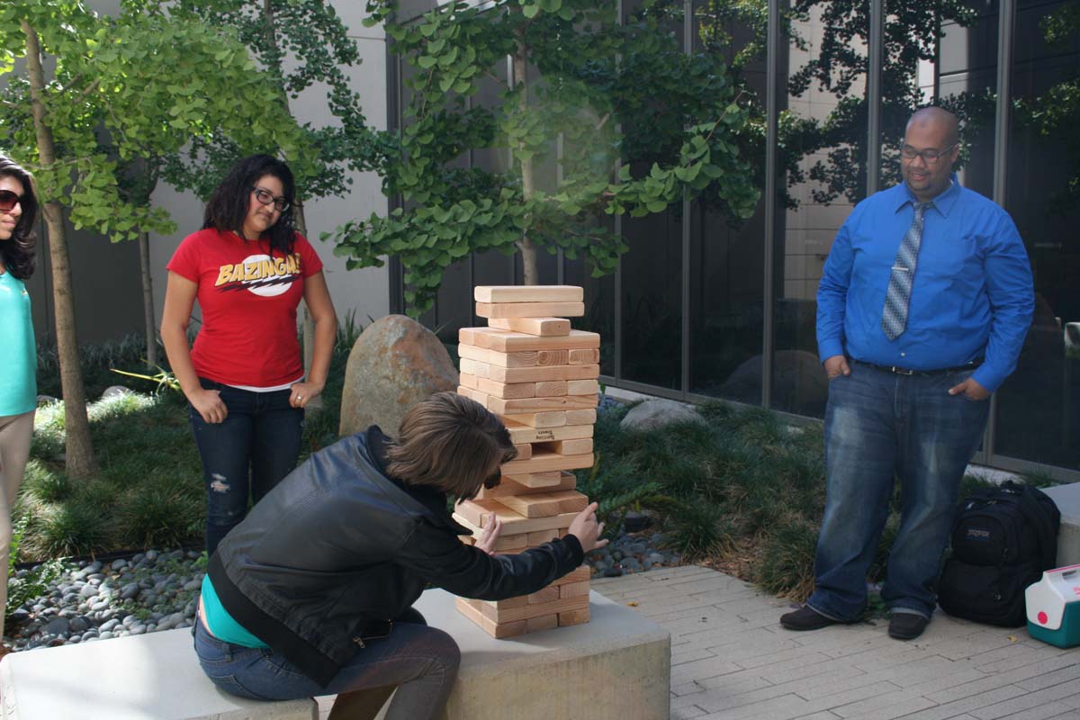 People playing giant Jenga