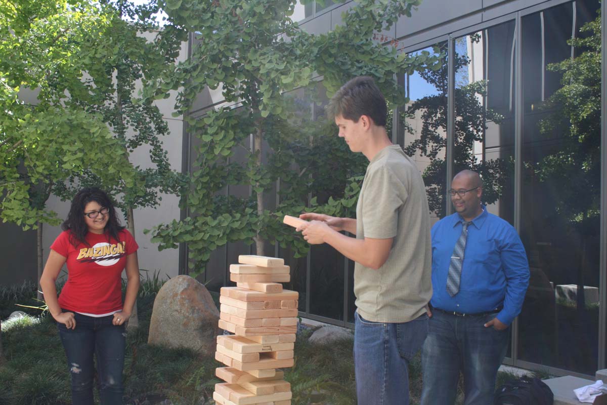 People playing giant Jenga