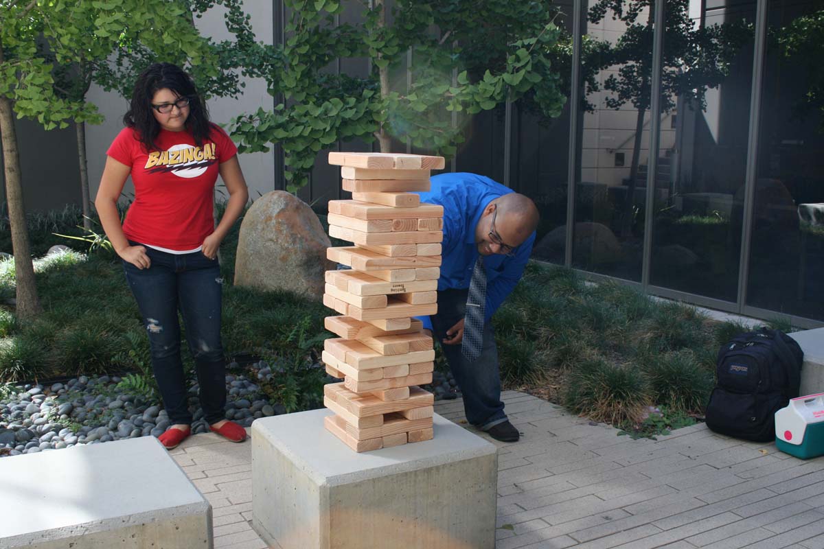 People playing giant Jenga