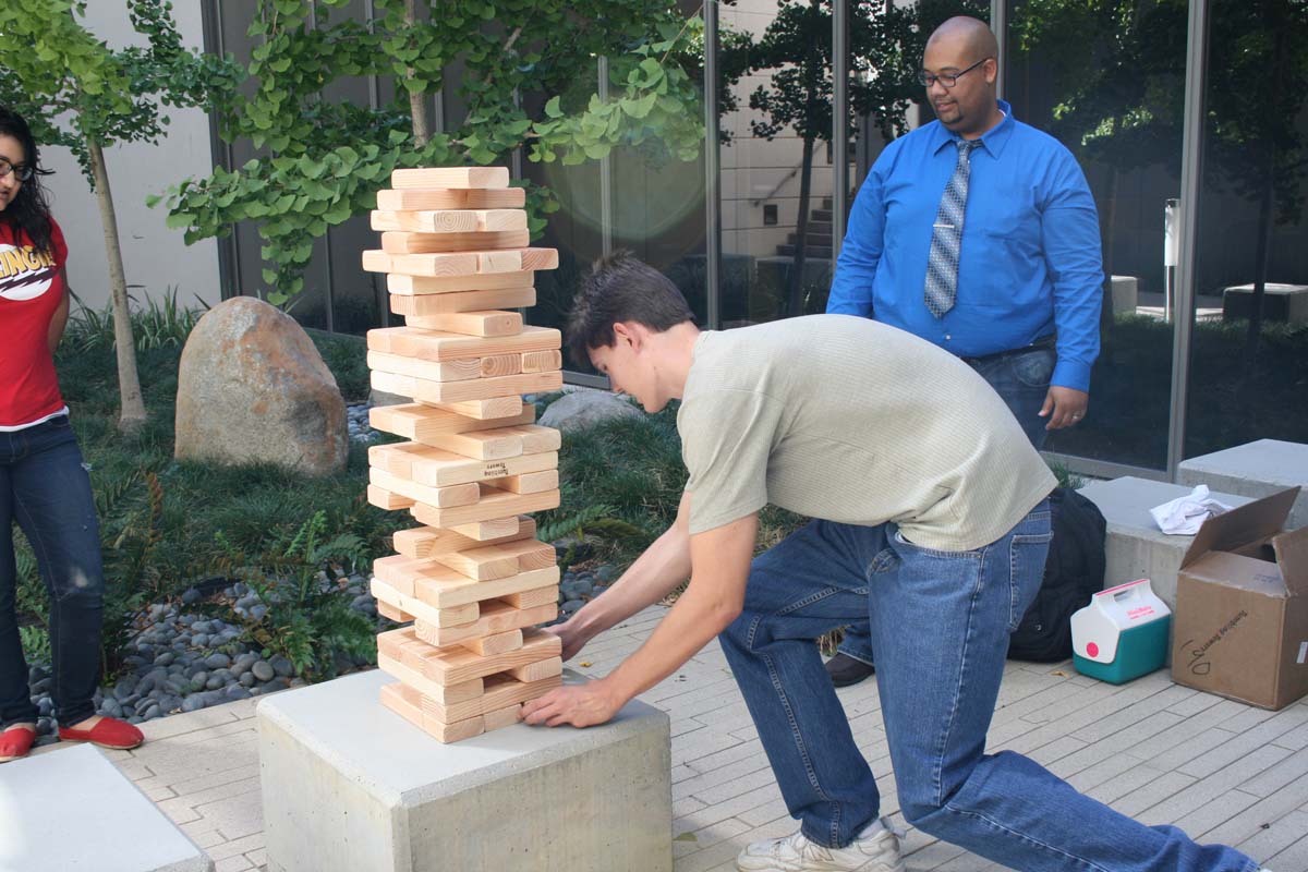 People playing giant Jenga