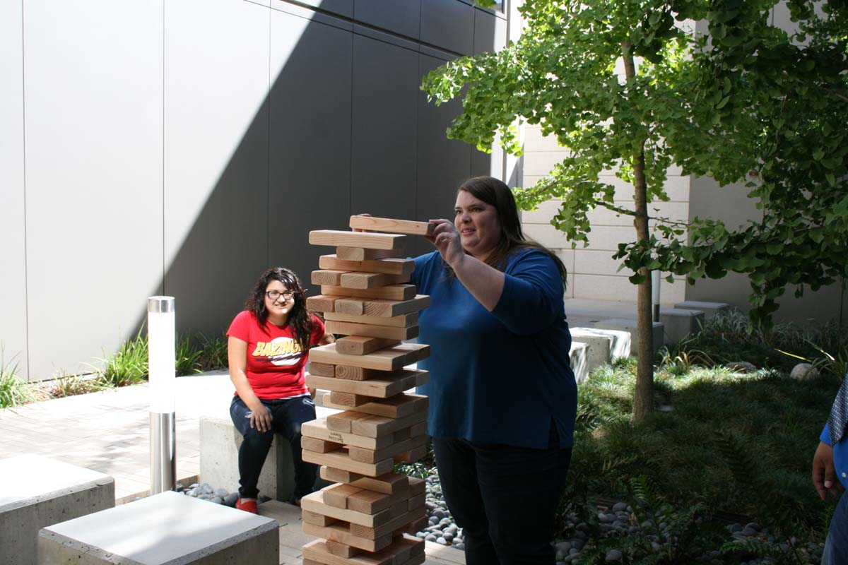 People playing giant Jenga