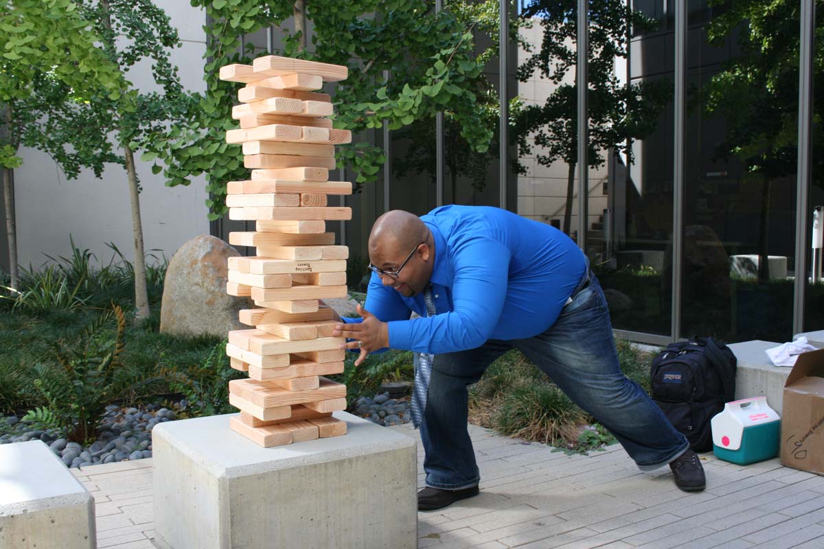 People playing giant Jenga