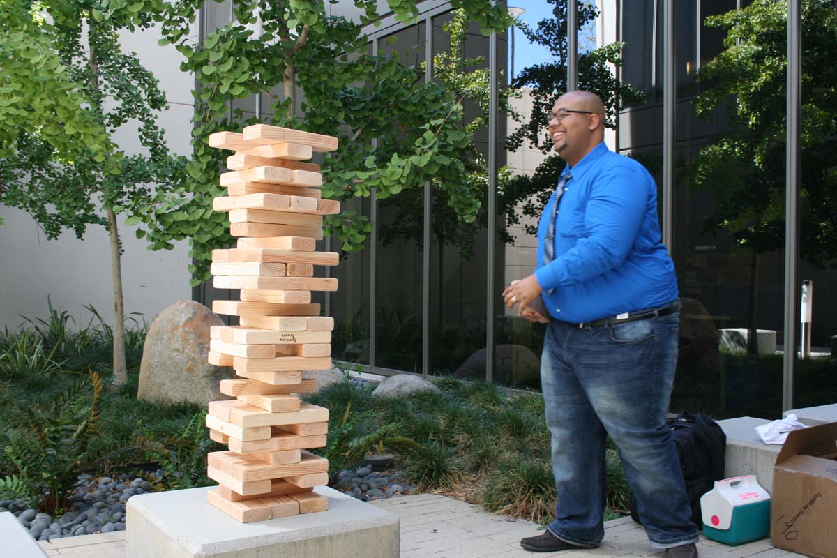 People playing giant Jenga