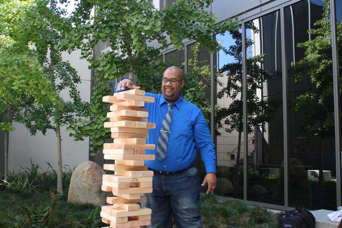 People playing giant Jenga