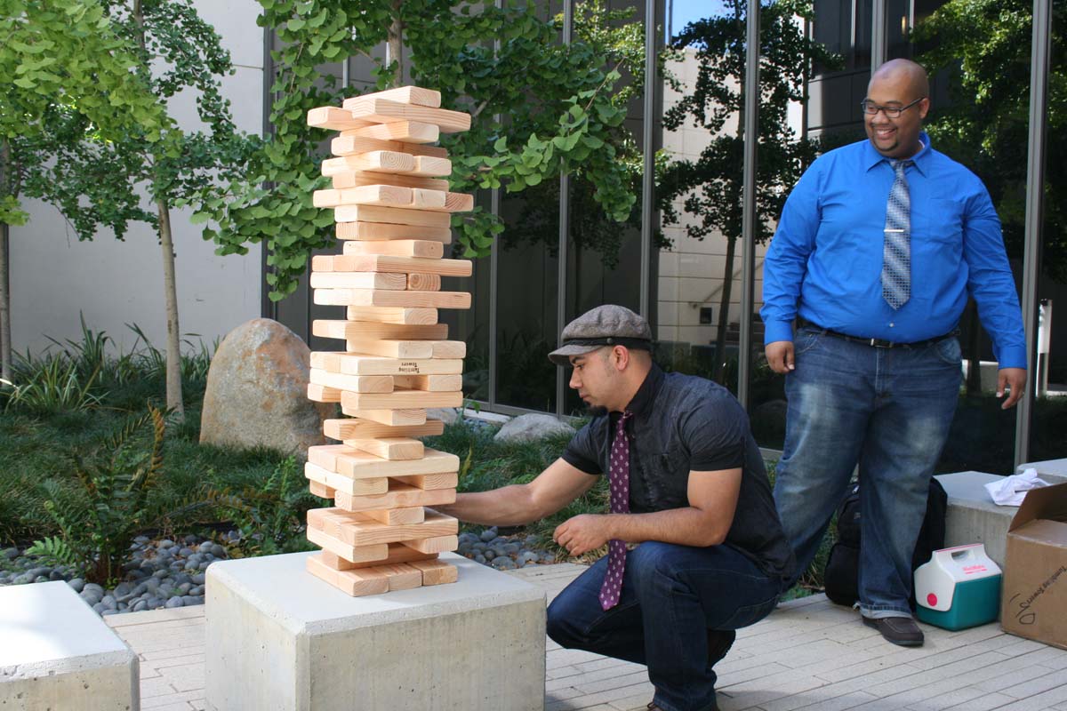 People playing giant Jenga