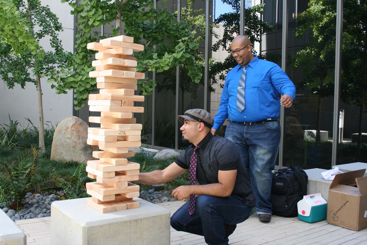 People playing giant Jenga