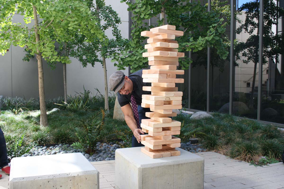 People playing giant Jenga