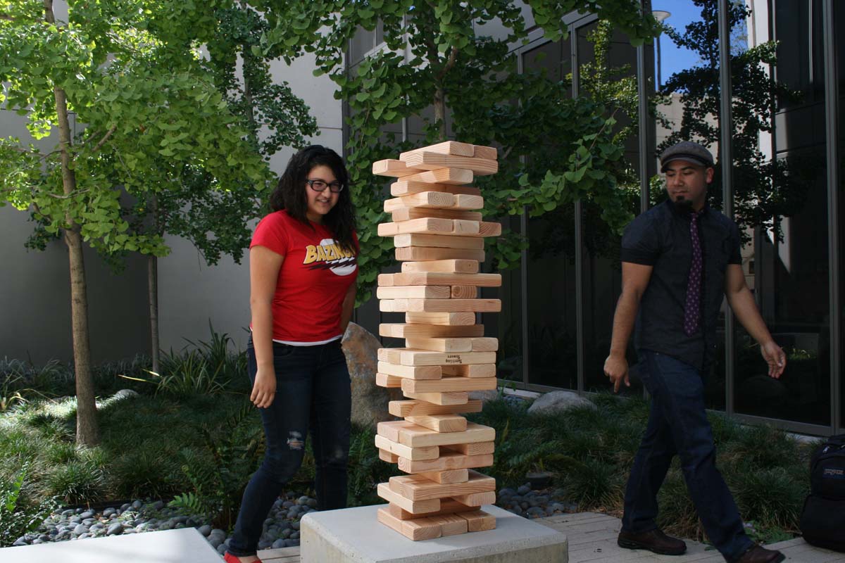People playing giant Jenga