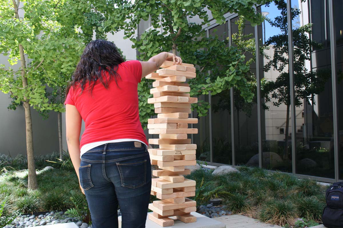People playing giant Jenga
