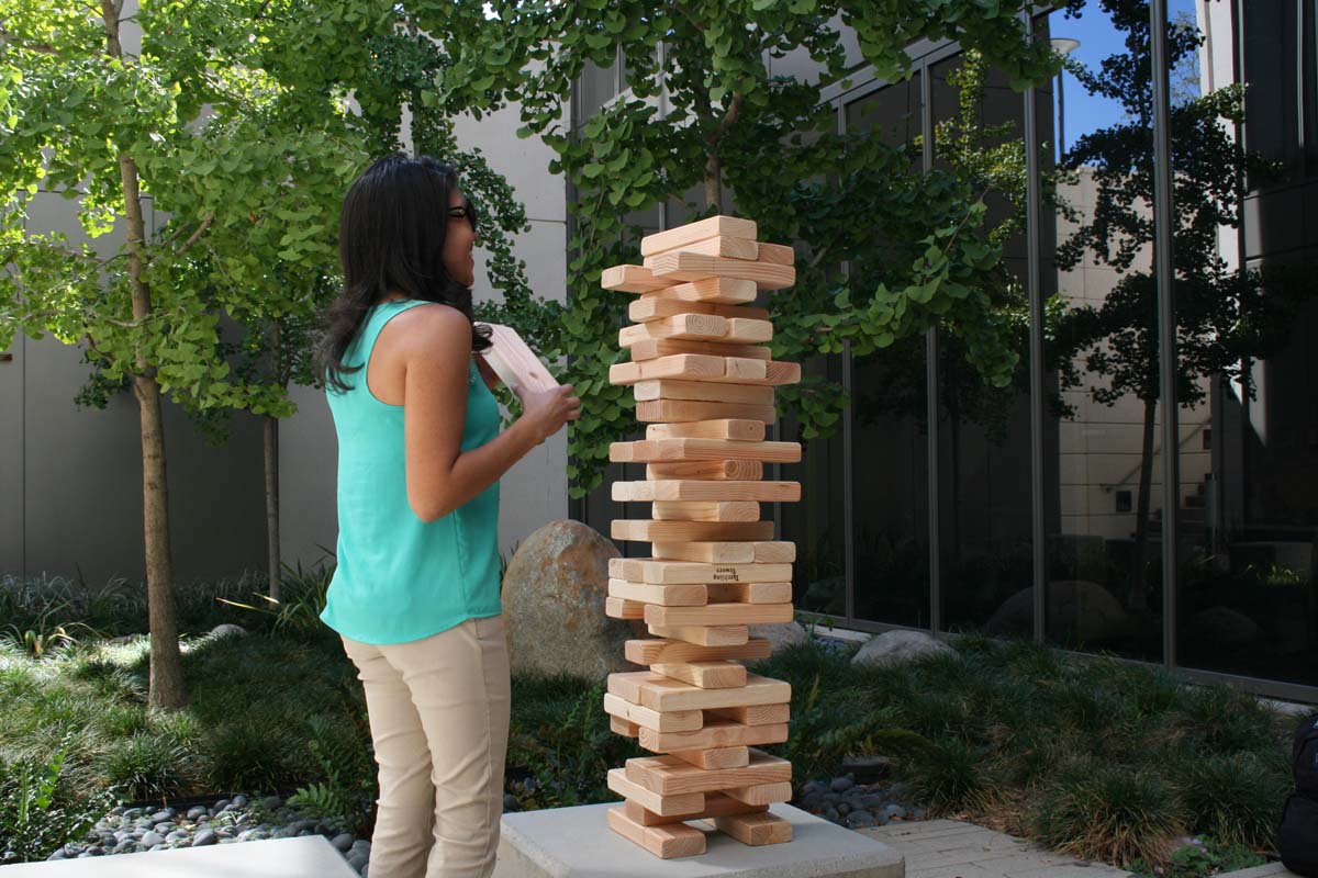 People playing giant Jenga