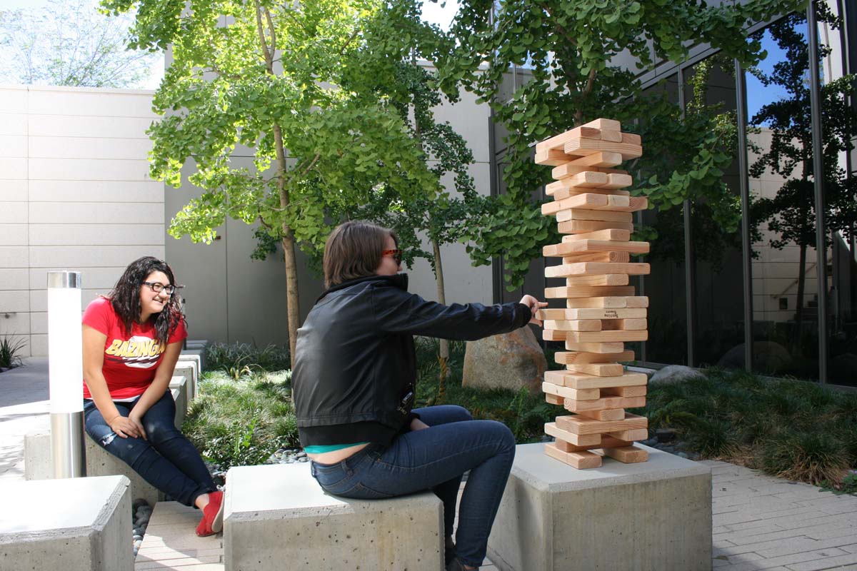 People playing giant Jenga