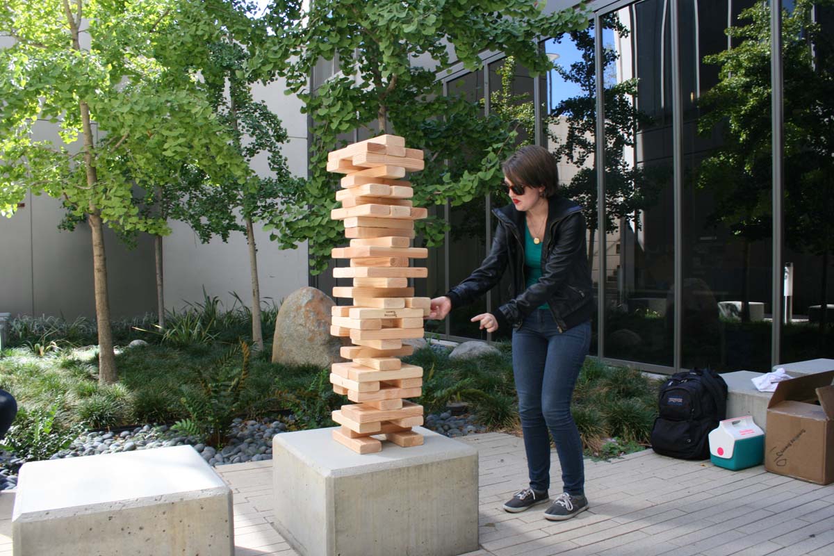 People playing giant Jenga