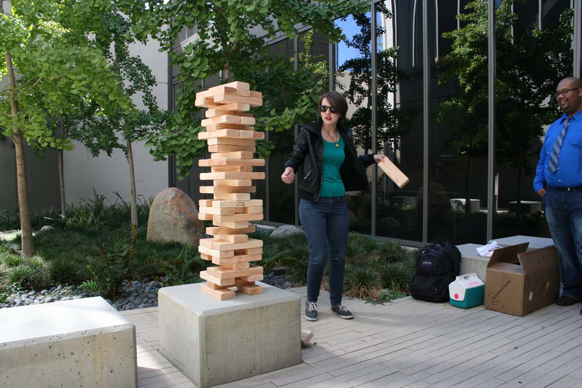 People playing giant Jenga