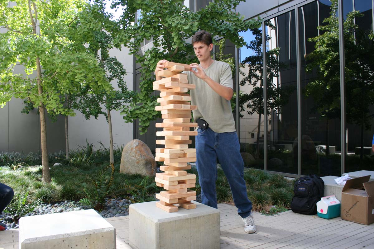 People playing giant Jenga