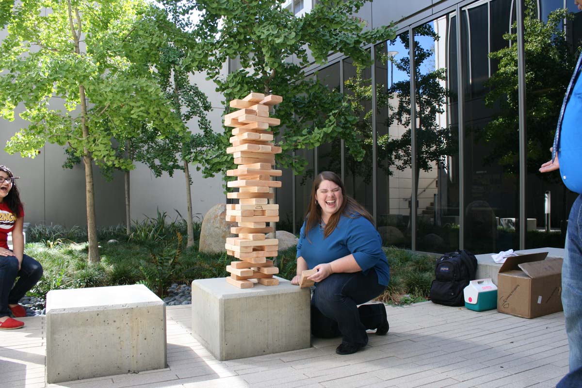 People playing giant Jenga
