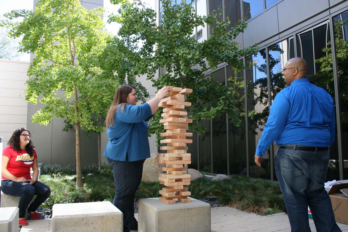 People playing giant Jenga