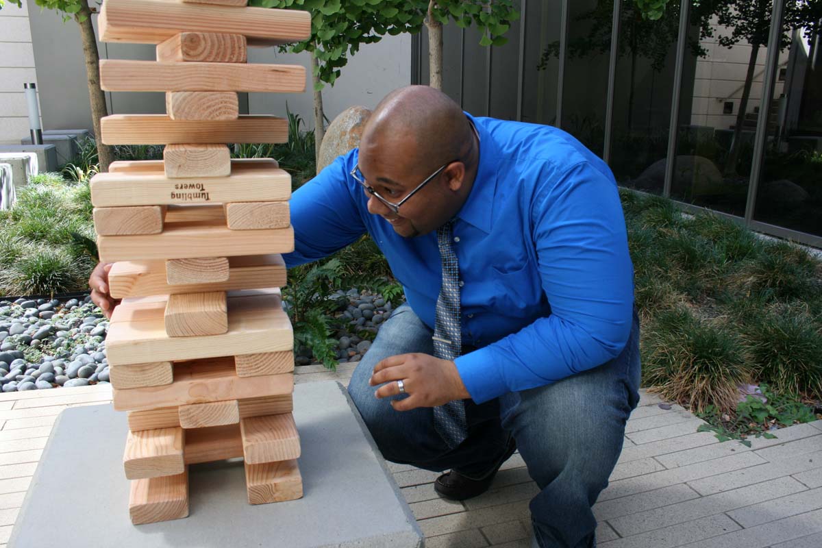 People playing giant Jenga