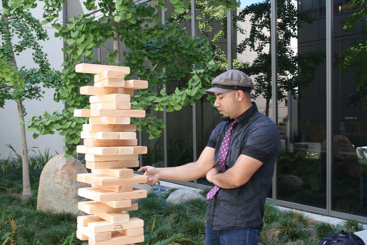 People playing giant Jenga
