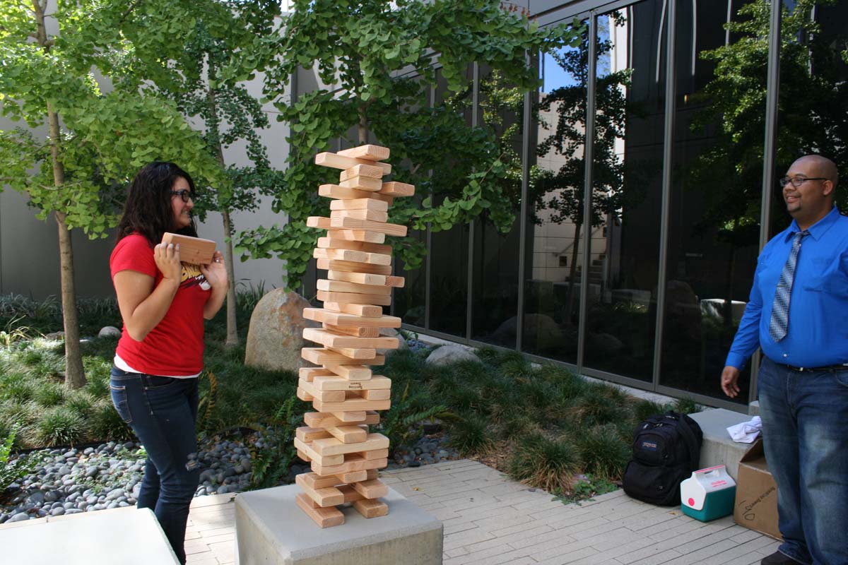 People playing giant Jenga