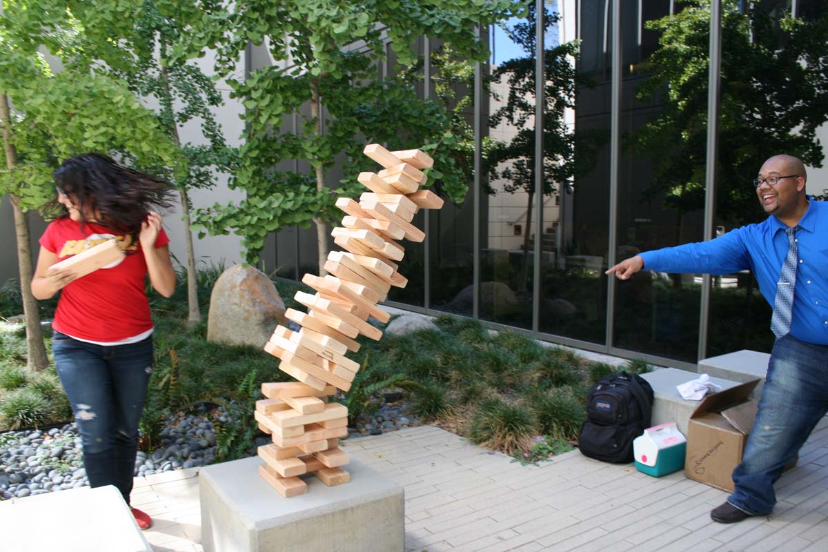 People playing giant Jenga