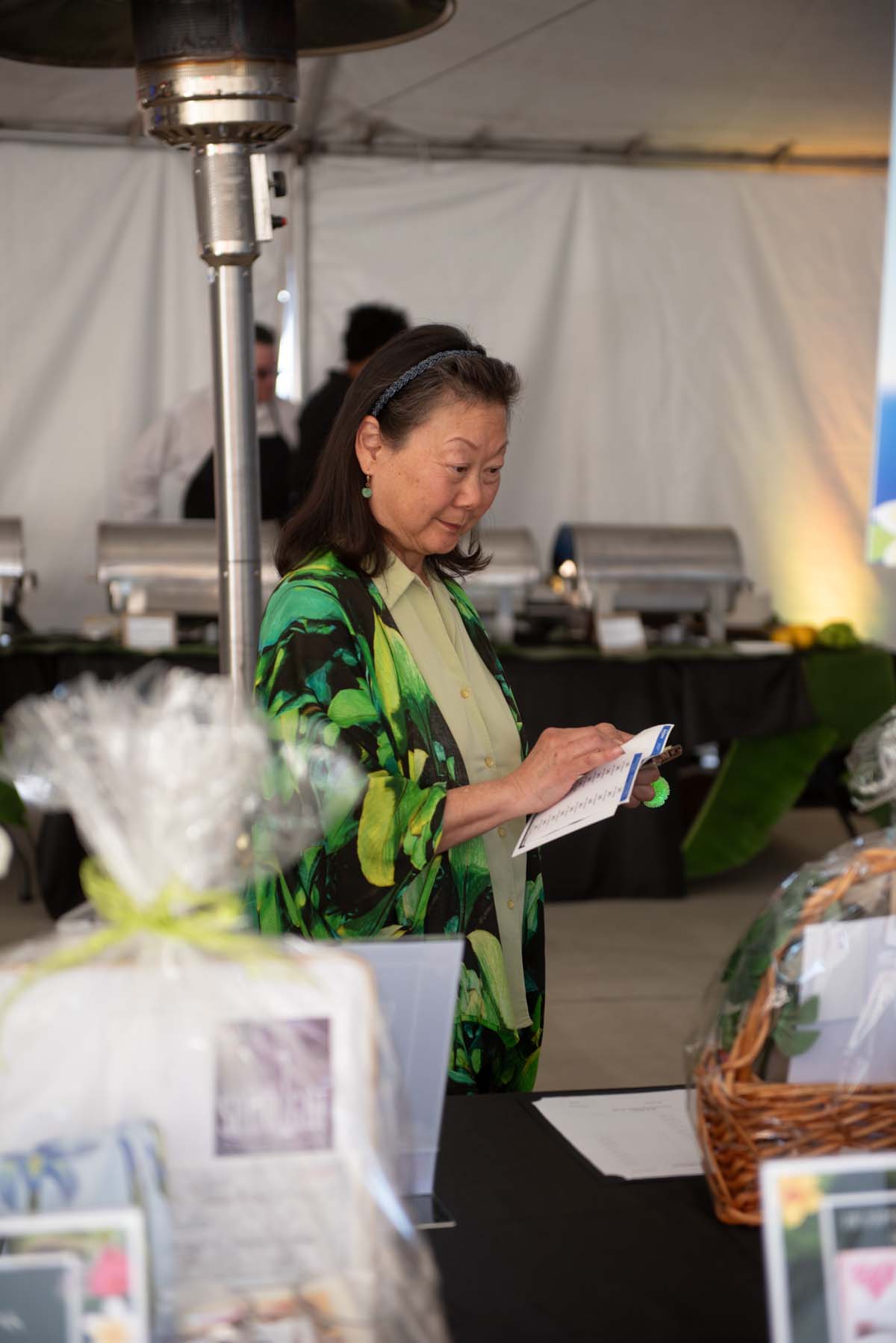 June Yamamoto looking at auction items