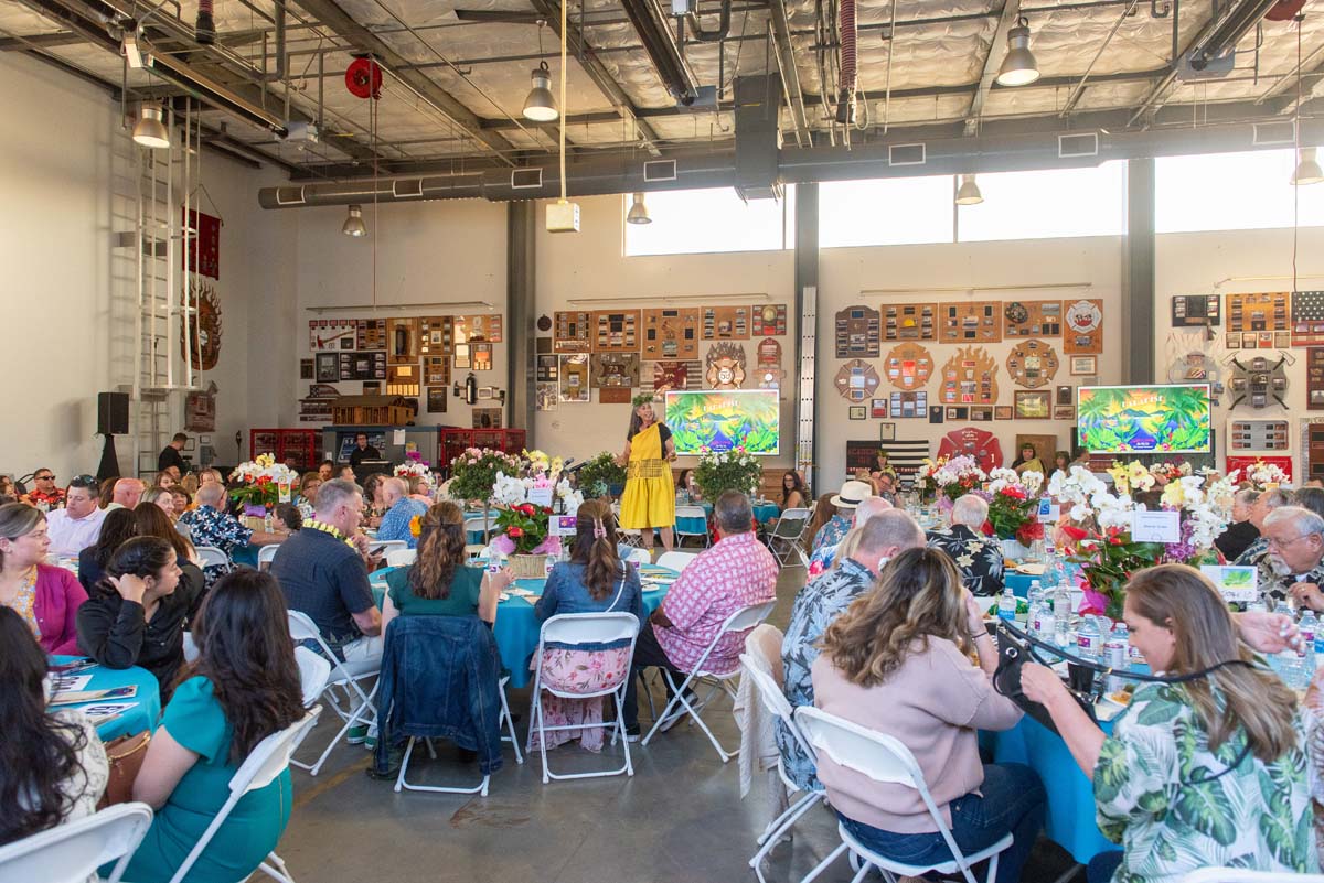 Tables full of people waching woman in costume