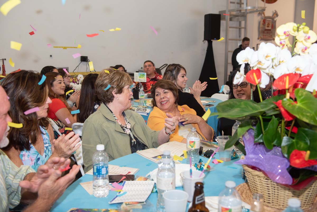 People at tables with confetti falling