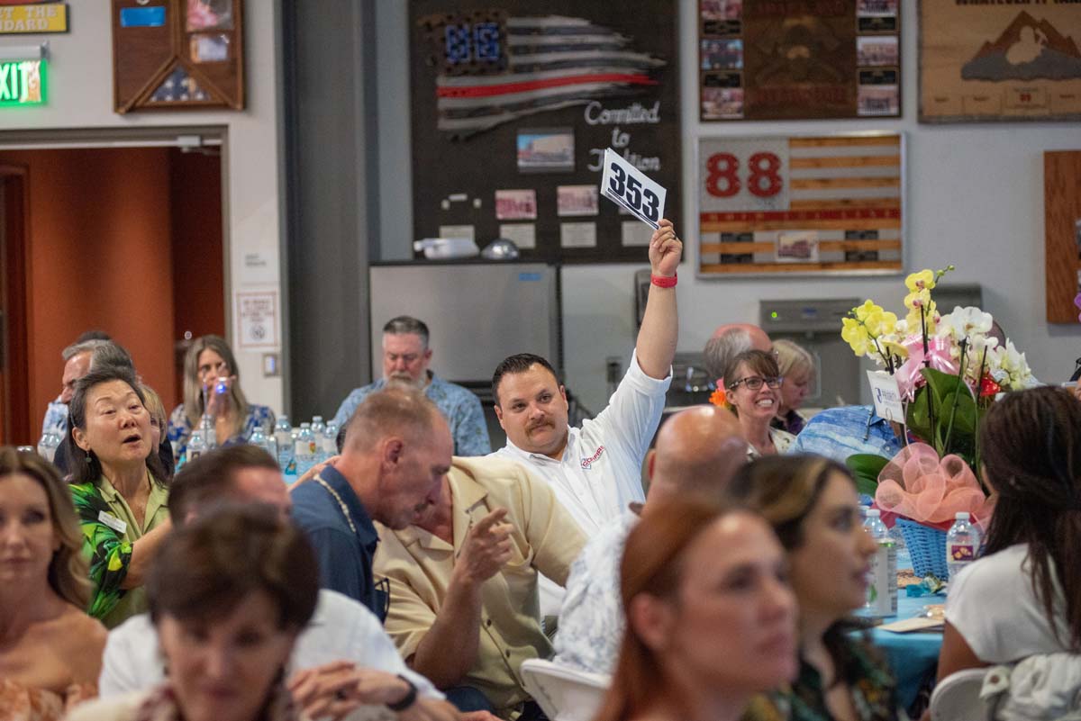 Person holding up bidding numbers