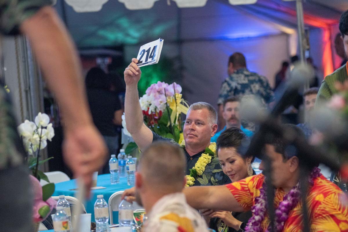 President Horan holding up bidding numbers