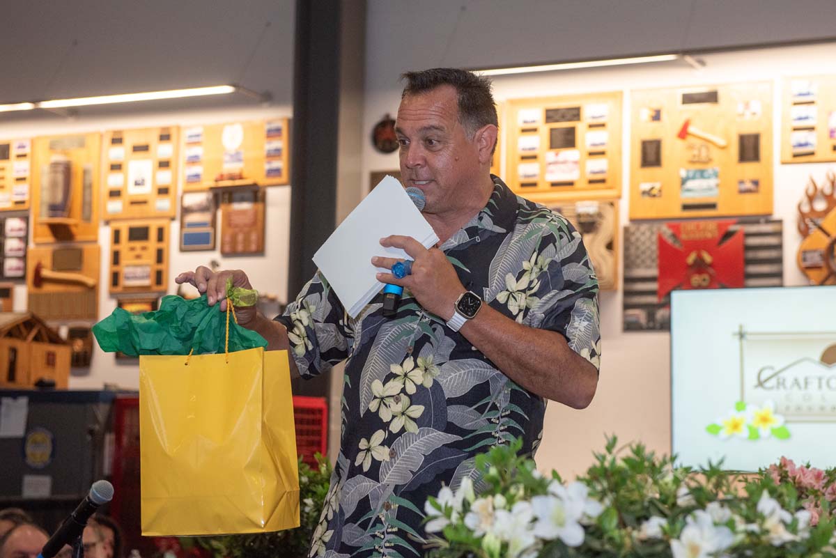 Man with microphone and gift bag