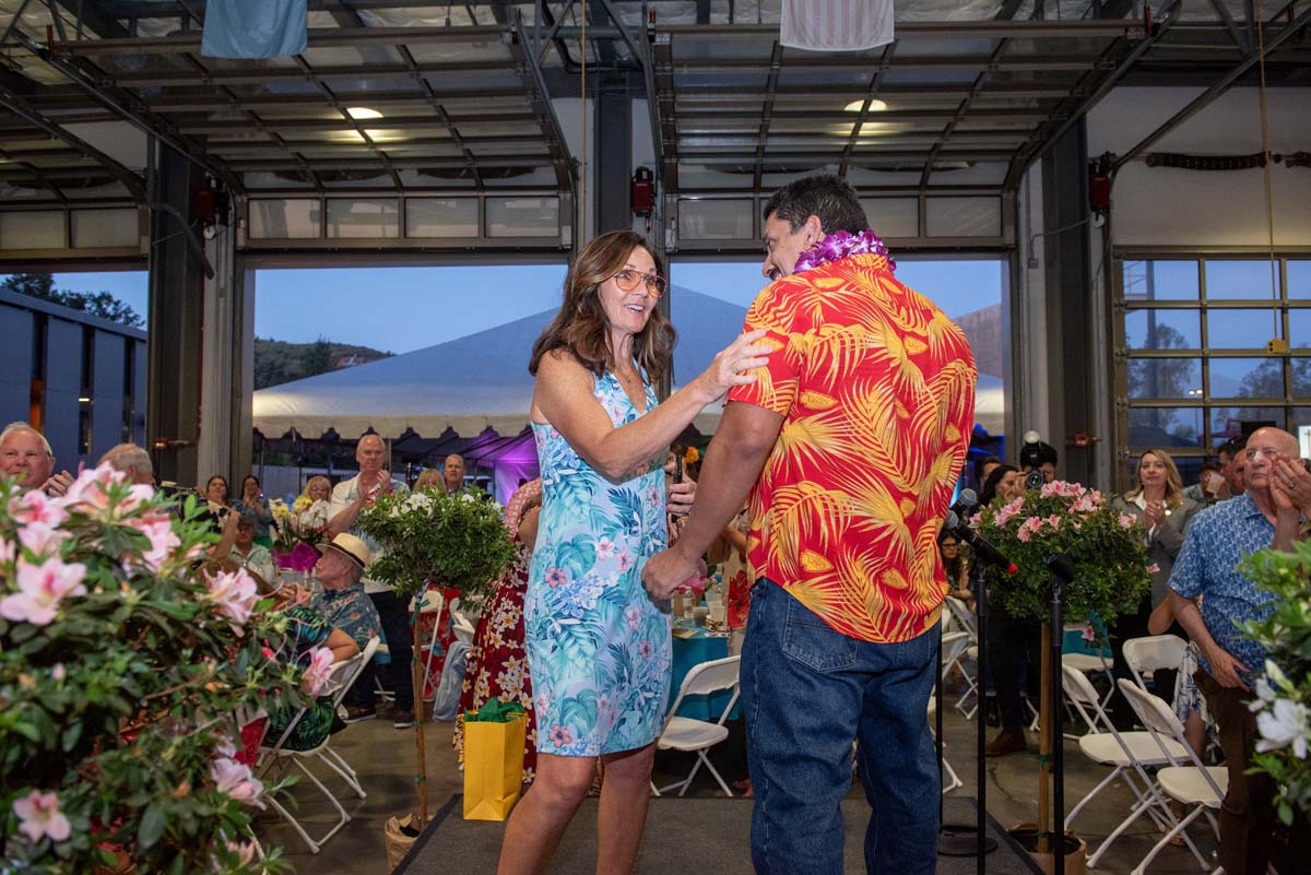 Woman touching a Damian's arm among tables