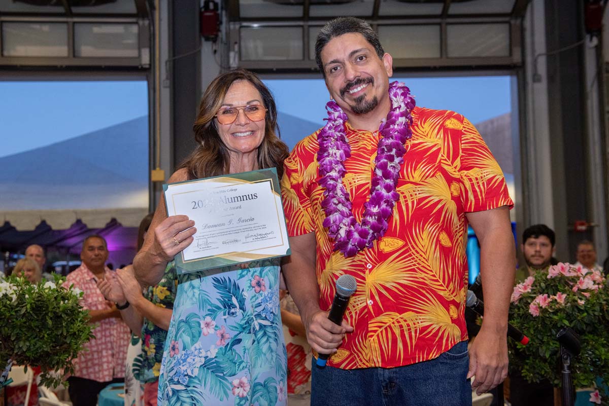 Woman with Damian and certificate