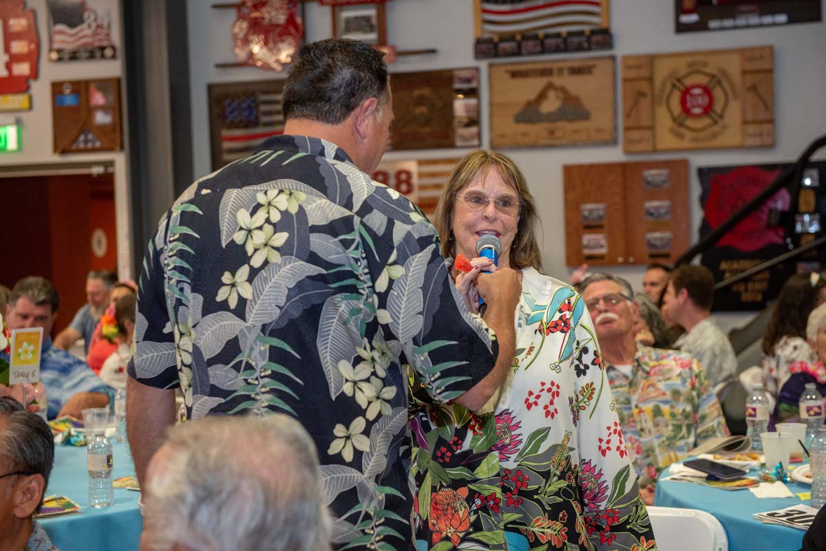 Man holding microphone for a woman