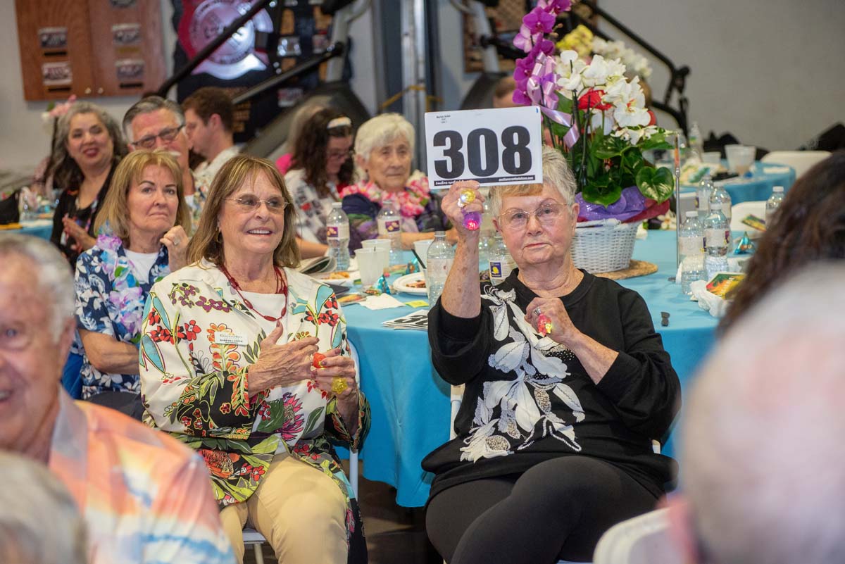 Woman holding up bidding number